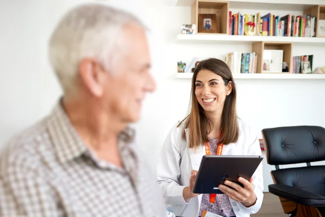 A medical professional attending a patient at home.